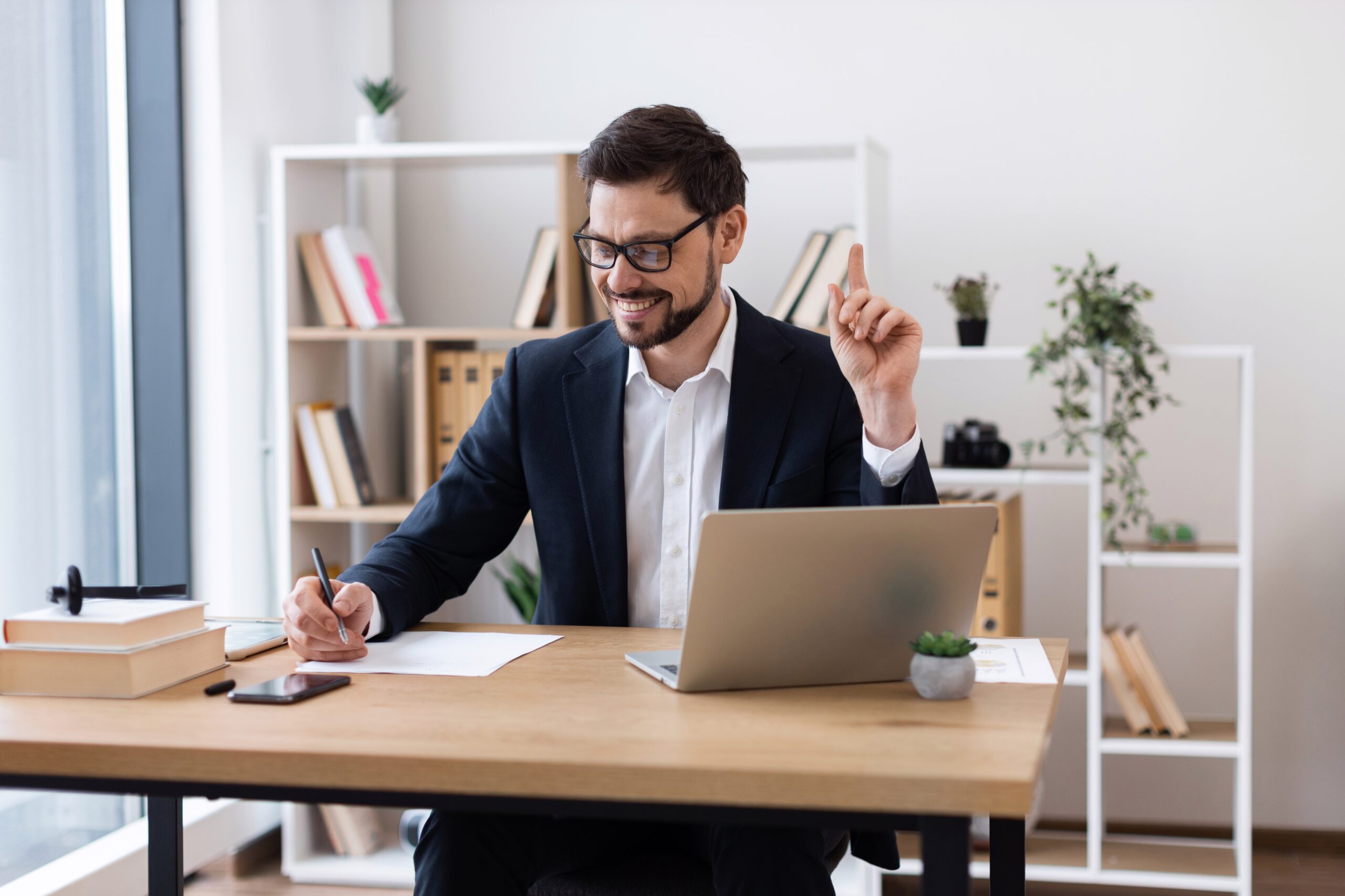Young,Adult,Caucasian,Male,Sitting,At,Computer,Writing,Notes,In