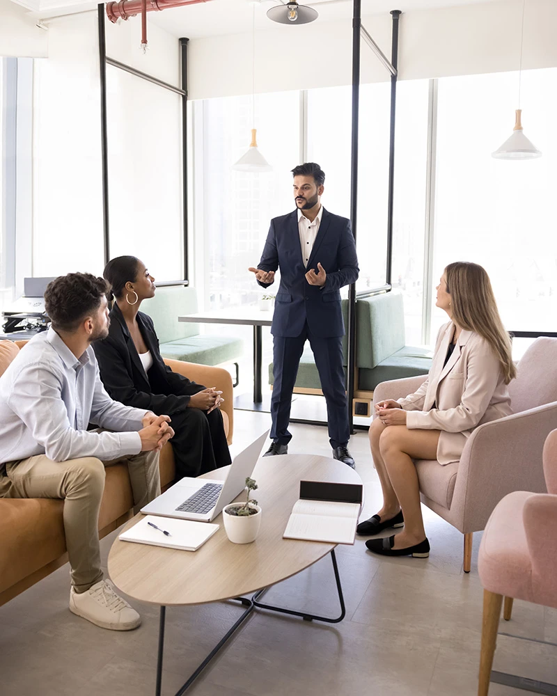 Male professional presenting to team